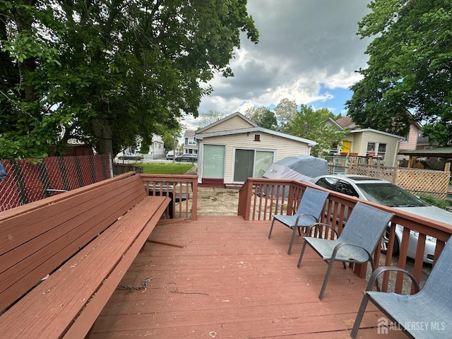 deck featuring fence and an outbuilding