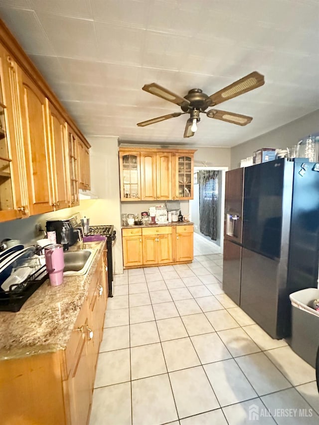 44 S Ward St, New Brunswick, NJ 08901 - kitchen featuring stainless steel refrigerator with ice dispenser, gas stove, light tile patterned floors, glass insert cabinets, and a ceiling fan