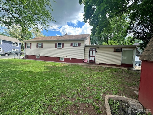 back of house featuring a yard and entry steps
