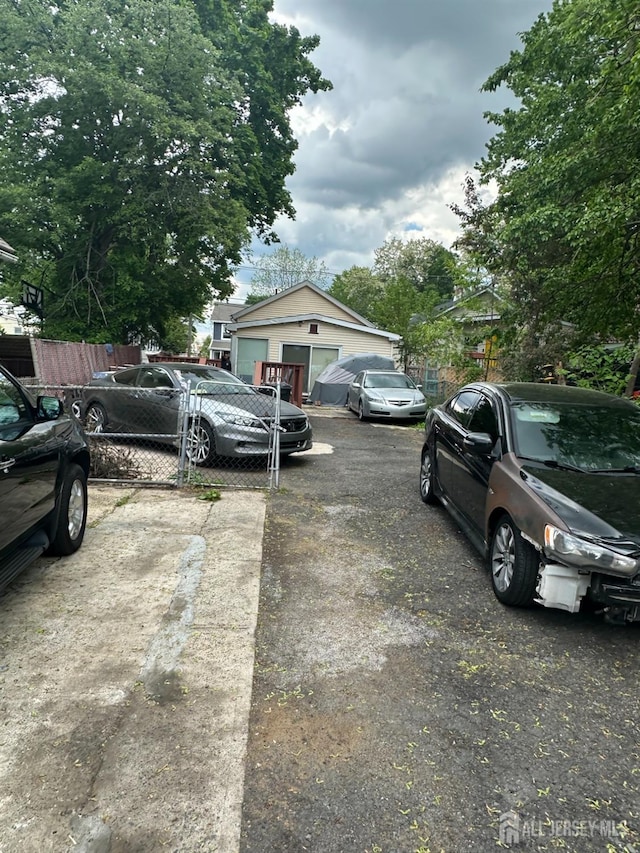 view of parking / parking lot with fence