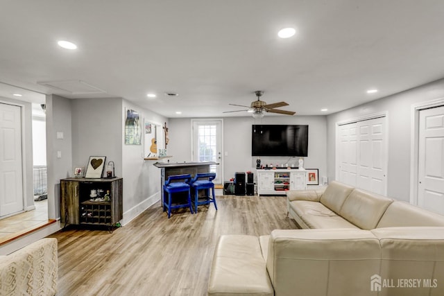 living area featuring a ceiling fan, wood finished floors, baseboards, attic access, and recessed lighting