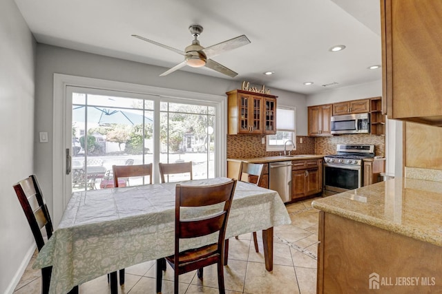 dining room with light tile patterned floors, baseboards, ceiling fan, and recessed lighting