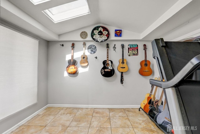 workout area with baseboards, tile patterned flooring, and vaulted ceiling