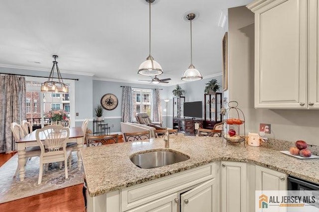 7203 Minuteman Ln, Franklin, NJ 08873 - kitchen with a peninsula, ornamental molding, pendant lighting, light stone counters, and open floor plan
