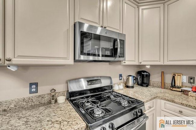7203 Minuteman Ln, Franklin, NJ 08873 - kitchen with appliances with stainless steel finishes, light stone counters, and white cabinetry
