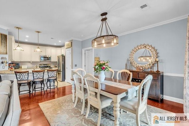 7203 Minuteman Ln, Franklin, NJ 08873 - dining room featuring light wood finished floors, recessed lighting, and ornamental molding