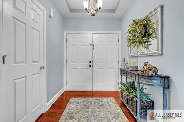 7203 Minuteman Ln, Franklin, NJ 08873 - entrance foyer featuring dark wood-style flooring and a chandelier