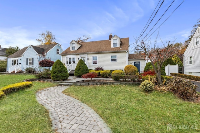 view of front facade featuring entry steps, a chimney, a front yard, and fence