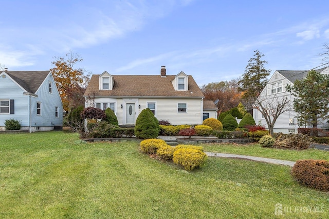 cape cod house with a front yard and a chimney