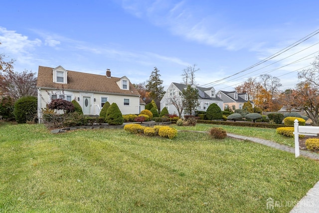 view of front of home with a chimney and a front lawn