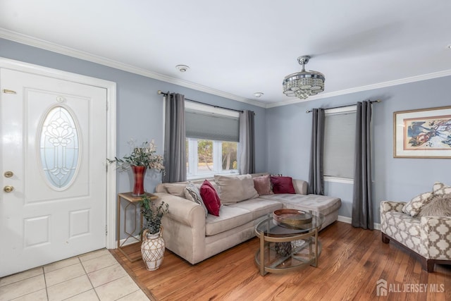 living room with ornamental molding and light wood-style flooring