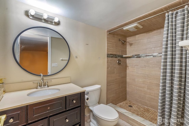 bathroom with visible vents, a tile shower, vanity, and toilet