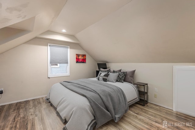 bedroom with vaulted ceiling, recessed lighting, light wood-type flooring, and baseboards