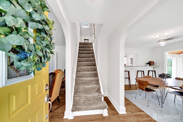 10 Shaw Dr, Franklin, NJ 08528 - foyer entrance featuring stairs, wood finished floors, arched walkways, and a ceiling fan