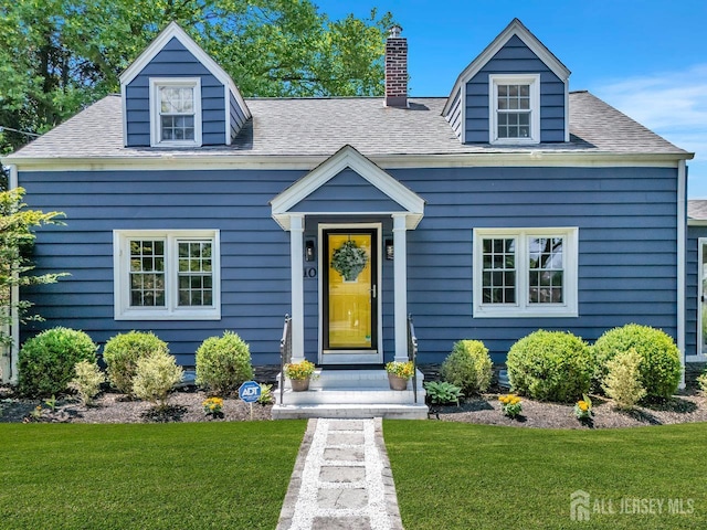 10 Shaw Dr, Franklin, NJ 08528 - view of front facade with a front yard, a chimney, and a shingled roof