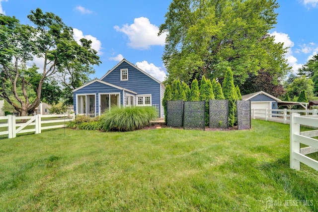 10 Shaw Dr, Franklin, NJ 08528 - rear view of house with a fenced backyard, a detached garage, and an outbuilding