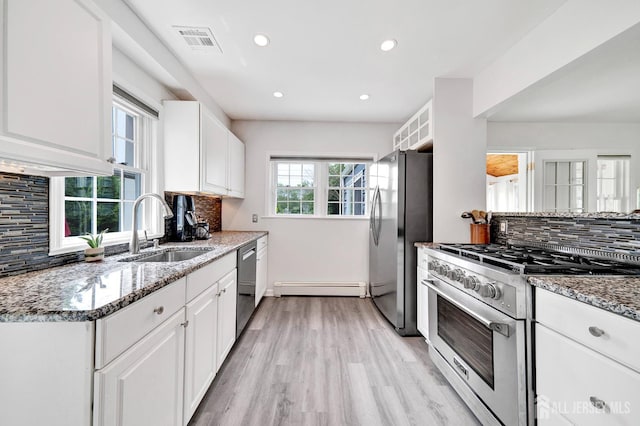 10 Shaw Dr, Franklin, NJ 08528 - kitchen featuring appliances with stainless steel finishes, a baseboard radiator, stone counters, light wood finished floors, and backsplash