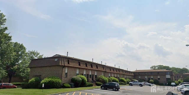 view of property featuring uncovered parking