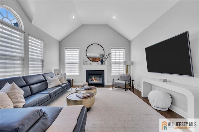 11 Hawk Ct, East Brunswick, NJ 08816 - living room featuring wood finished floors, lofted ceiling, a glass covered fireplace, and recessed lighting