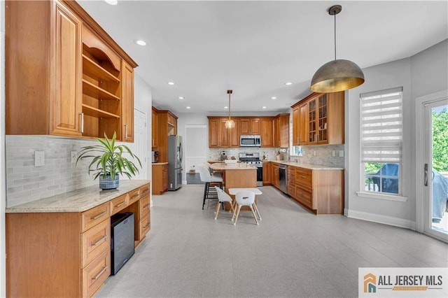 11 Hawk Ct, East Brunswick, NJ 08816 - kitchen featuring appliances with stainless steel finishes, open shelves, a kitchen breakfast bar, tasteful backsplash, and glass insert cabinets