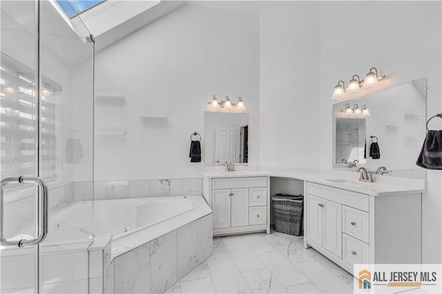 11 Hawk Ct, East Brunswick, NJ 08816 - bathroom featuring high vaulted ceiling, marble finish flooring, a garden tub, vanity, and a skylight