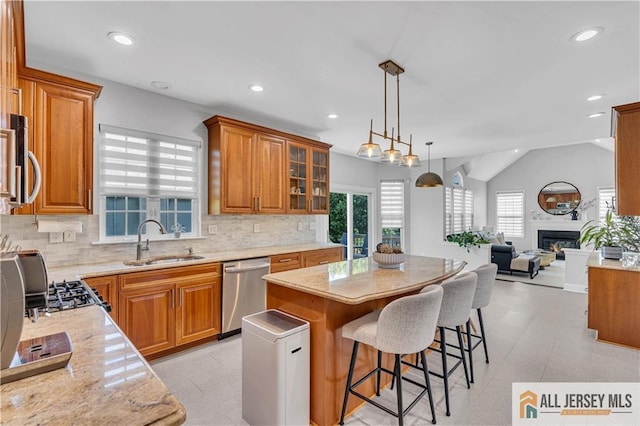 11 Hawk Ct, East Brunswick, NJ 08816 - kitchen with stainless steel appliances, brown cabinetry, a kitchen island, open floor plan, and backsplash