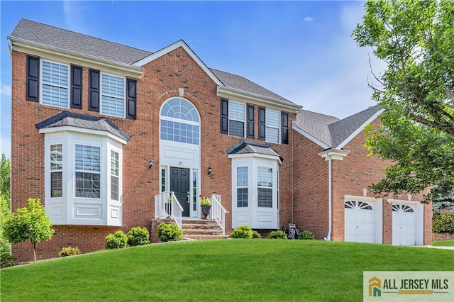 11 Hawk Ct, East Brunswick, NJ 08816 - view of front of house with a front yard, brick siding, and a garage