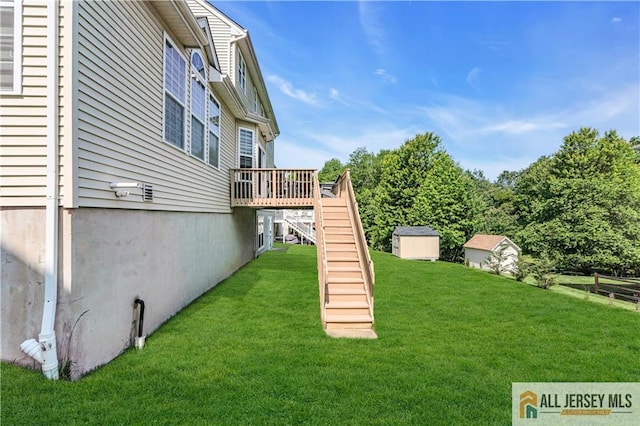11 Hawk Ct, East Brunswick, NJ 08816 - view of grassy yard featuring stairs, a wooden deck, and a storage unit