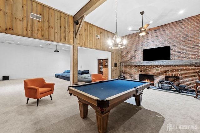 game room featuring visible vents, carpet floors, a fireplace, wood walls, and beamed ceiling