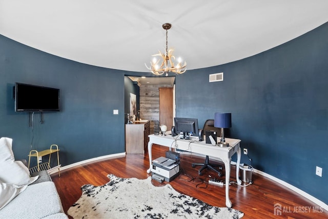 office with a chandelier, visible vents, baseboards, and wood finished floors