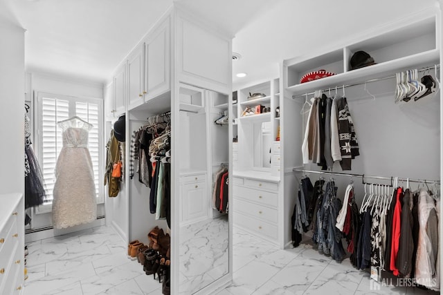 spacious closet featuring marble finish floor