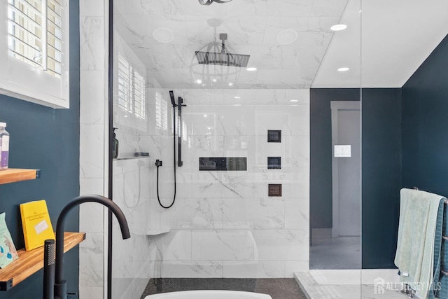 bathroom featuring a sink and a marble finish shower