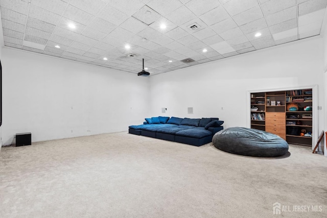 living area featuring recessed lighting, visible vents, and carpet