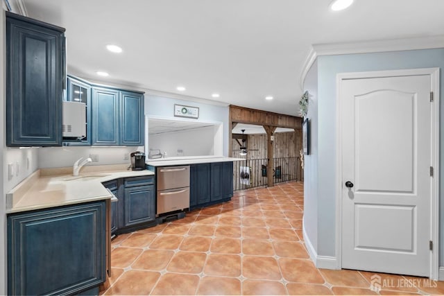 kitchen with recessed lighting, crown molding, blue cabinets, and a sink