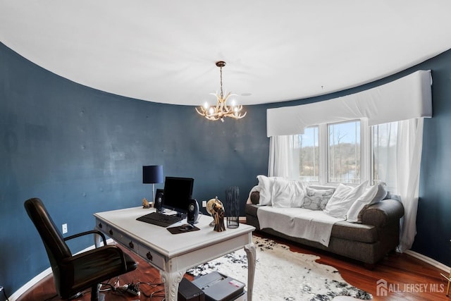 office space featuring a chandelier, baseboards, and wood finished floors