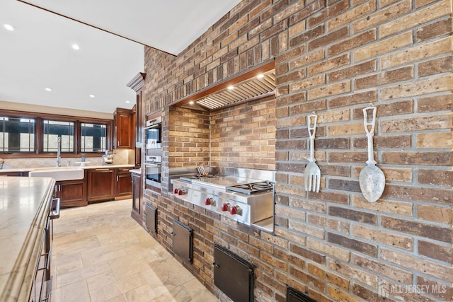 13 Eagle Nest Rd, Colts Neck, NJ 07722 - kitchen featuring a sink, appliances with stainless steel finishes, light stone finish flooring, light countertops, and custom range hood