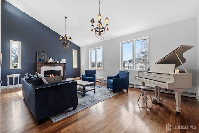 living area with high vaulted ceiling, a warm lit fireplace, wood-type flooring, baseboards, and a chandelier