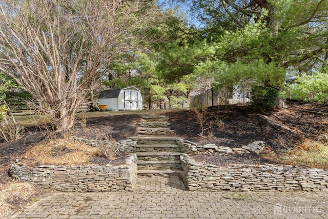 view of yard featuring a storage shed and an outbuilding