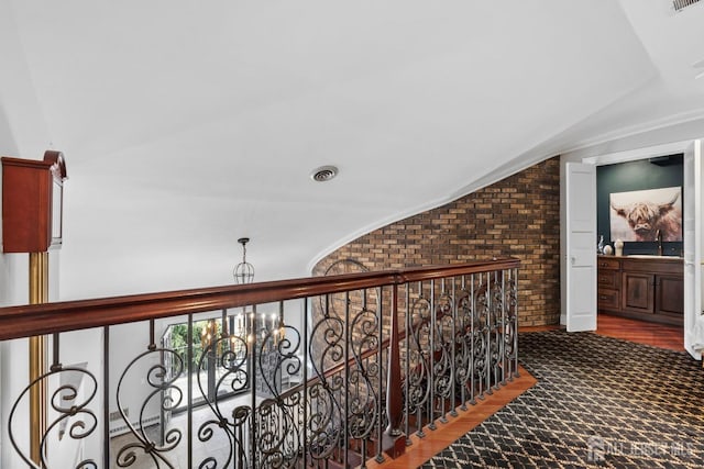 13 Eagle Nest Rd, Colts Neck, NJ 07722 - hall with brick wall, a sink, wood finished floors, and lofted ceiling