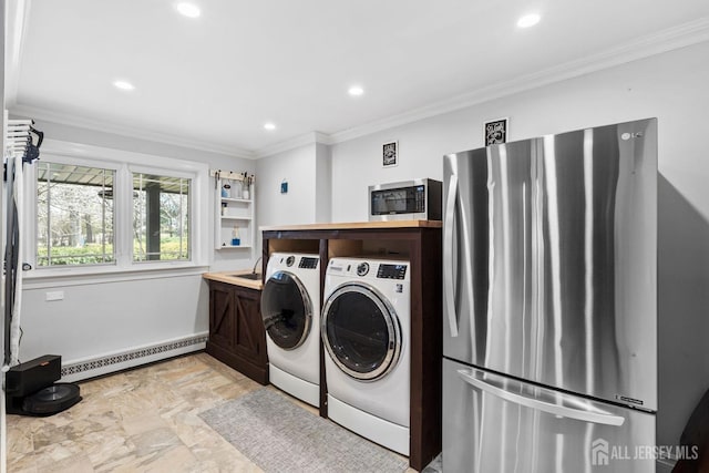 clothes washing area with baseboard heating, laundry area, and ornamental molding