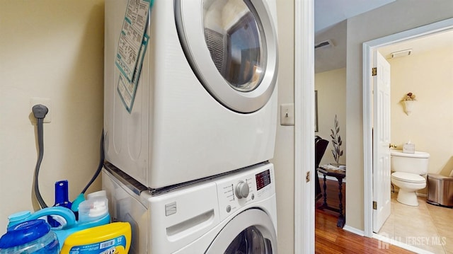 1406 Locust Ct, South Brunswick, NJ 08852 - washroom featuring estacked washer and dryer and wood finished floors