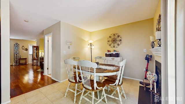 1406 Locust Ct, South Brunswick, NJ 08852 - dining room with tile patterned floors and a fireplace with flush hearth