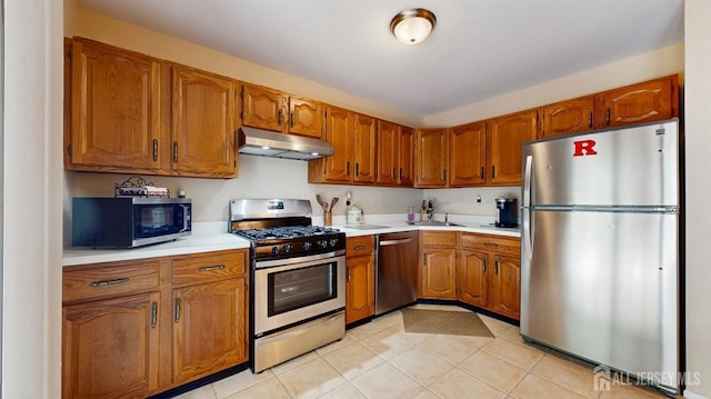 1406 Locust Ct, South Brunswick, NJ 08852 - kitchen featuring stainless steel appliances, under cabinet range hood, brown cabinets, light countertops, and light tile patterned flooring