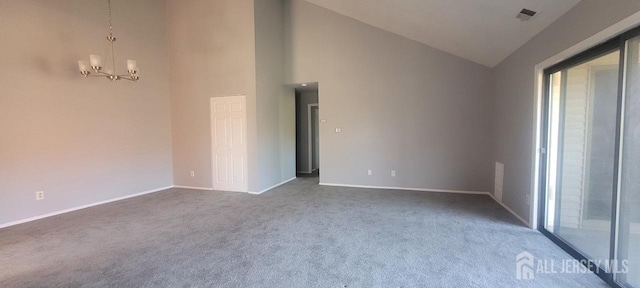 spare room with a notable chandelier, baseboards, dark carpet, and high vaulted ceiling