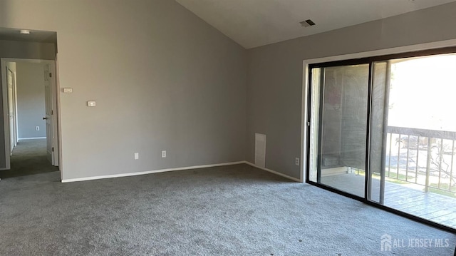 carpeted spare room featuring lofted ceiling, baseboards, and visible vents