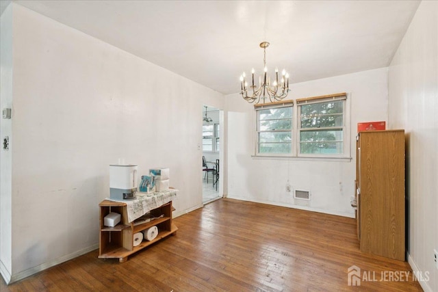 796 Curie Rd, North Brunswick, NJ 08902 - dining space with a chandelier and wood finished floors