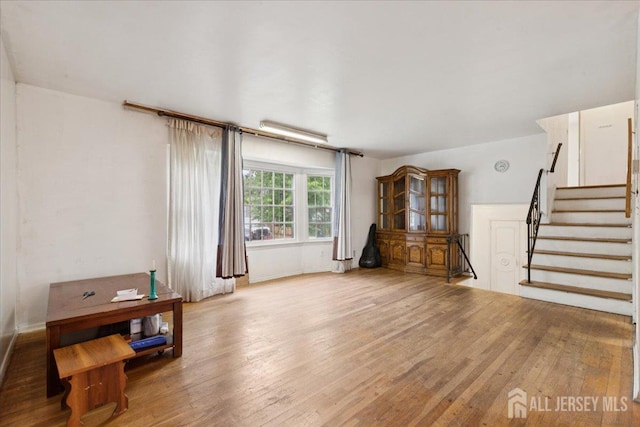 796 Curie Rd, North Brunswick, NJ 08902 - unfurnished living room with wood-type flooring and stairway