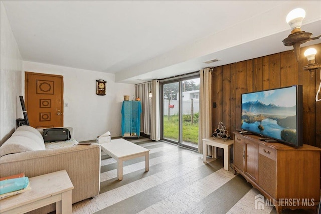 796 Curie Rd, North Brunswick, NJ 08902 - living area featuring light wood-style floors and wooden walls
