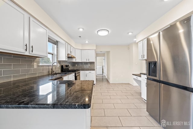 96 Lark Dr, South River, NJ 08882 - kitchen with stainless steel appliances, a peninsula, white cabinets, dark stone counters, and tasteful backsplash