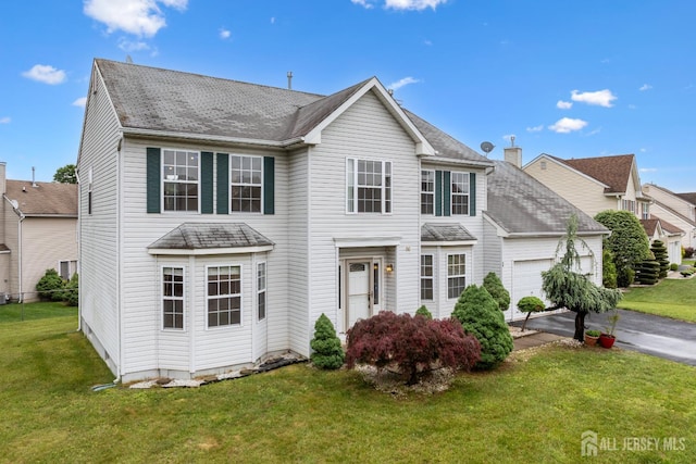 96 Lark Dr, South River, NJ 08882 - traditional home with an attached garage, a front yard, and asphalt driveway